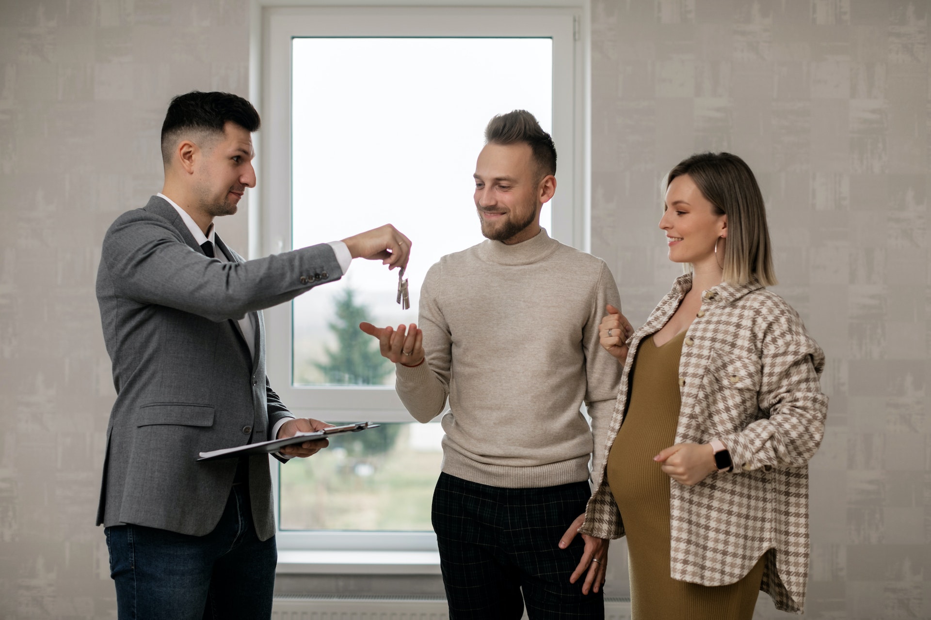 real estate agent handing over keys to homeowner